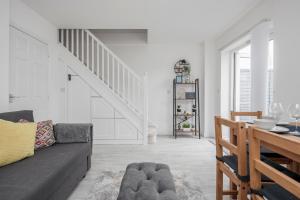 a living room with a couch and a staircase at Dartford Kent Smart Nest in Dartford