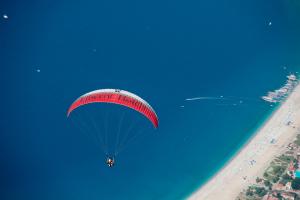 
a kite flying in the air over a beach at Liberty Lykia Adults Only in Oludeniz
