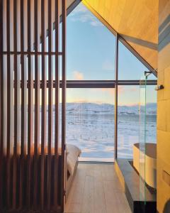 a bedroom with a view of the ocean at Iceland Lakeview Retreat in Selfoss