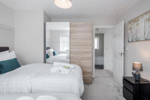 a bedroom with two beds and a large mirror at Dartford Kent Smart Nest in Dartford