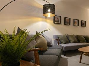 a living room with couches and a potted plant at Spacious City Centre Property in Lancaster