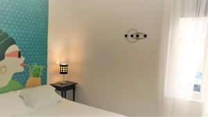 a bedroom with a bed and a clock on the wall at Apartamento Exterior en PARQUE DEL RETIRO- IBIZA DC in Madrid