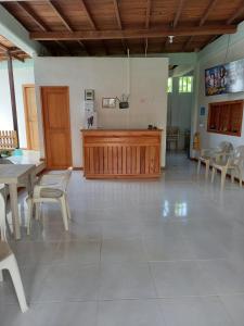 a large room with tables and chairs and a courtroom at Hostal Zurymar Capurganá in Capurganá