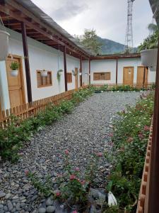 a courtyard of a house with a gravel road at Hostal Zurymar Capurganá in Capurganá