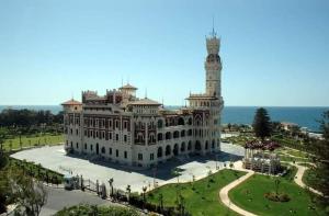 a large white building with a clock tower on top at Maamoura Beach 1 in Alexandria