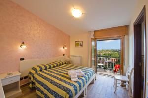 a bedroom with a bed and a balcony at Mamaral in Agerola