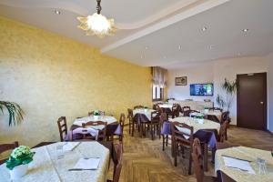 a dining room with tables and chairs and a chandelier at Mamaral in Agerola