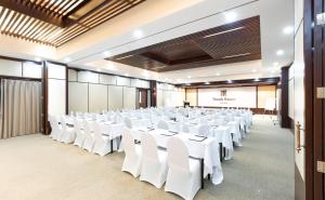 a large room with white tables and chairs in it at Tmark Resort Vangvieng in Vang Vieng