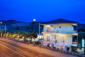 a house on the side of a street at night at Asteria Studios in Potos