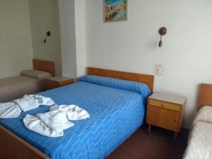 Ένα ή περισσότερα κρεβάτια σε δωμάτιο στο Hostería San Remo