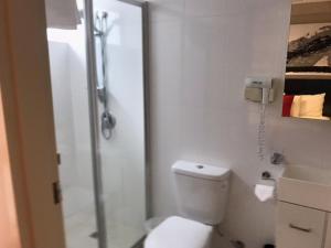 a bathroom with a toilet and a glass shower at Apartments on Chapman in Melbourne