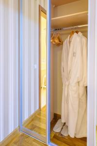 a bathroom with a mirror and a towel rack at Hotel Krasnoyarsk in Krasnoyarsk