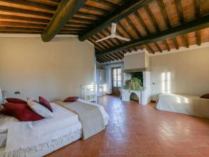 a large bedroom with two beds and a fireplace at Timeless Tuscan Holiday Stay in Arezzo +31 photos