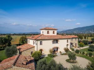 a large white building with a tower on top of it at Timeless Tuscan Holiday Stay in Arezzo