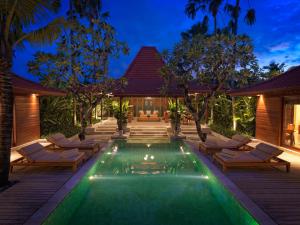 a swimming pool in the backyard of a villa at The Legian Seminyak, Bali in Seminyak