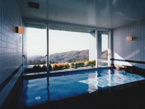 a swimming pool with a view of a mountain at 湘南リリーフ in Yokosuka