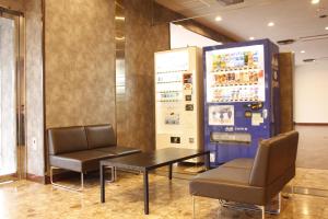a meeting room with two chairs and a table at Tabist Hotel New Osamura Sabae Inter in Fukui
