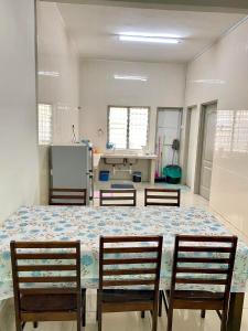 a room with a large table with three chairs at Azzalea Terrace House @ Golden Hills Night Market Cameron Highlands in Brinchang