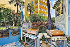 two stoves sitting on tables next to a building at Beach Palms in Clearwater Beach