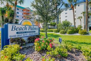 a sign for the beach palms resort with flowers at Beach Palms in Clearwater Beach