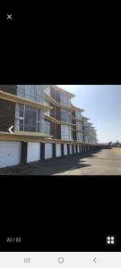 two pictures of a building with a building at Rockview Holiday Beach Apartment in Hibberdene
