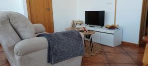 Televízia a/alebo spoločenská miestnosť v ubytovaní Loft Turístico