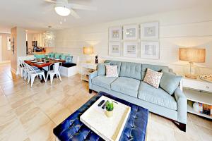 salon z niebieską kanapą i jadalnią w obiekcie Summerhouse Condo w mieście St. Augustine