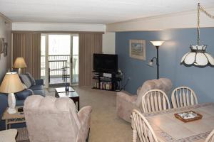a living room with a couch and chairs and a television at Sandpiper Dunes II in Ocean City