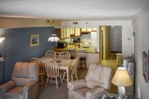 a living room with a table and chairs and a kitchen at Sandpiper Dunes II in Ocean City
