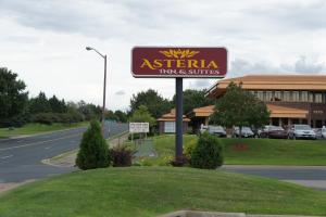 a sign for a restaurant in front of a building at Coratel Inn and Suites Maple Grove in Maple Grove