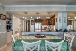 a kitchen and dining room with a table and chairs at Sea Watch Condos IX in Ocean City