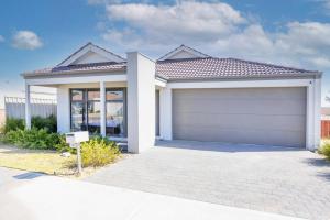 a house with a garage in front of it at The Kingsley’s Place - EXECUTIVE ESCAPES in Perth