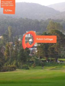 a poster of a golf course with an orange sign at Dutch Cottage in Nuwara Eliya