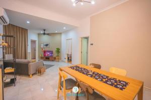 a living room with a table and a couch at Doorstep - Sunway Putra Mall - Close to PWTC for 4 in Kuala Lumpur