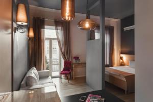 a room with a bed and a desk and a chair at UNO Design Hotel in Odesa