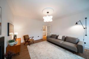 a living room with a couch and a table at Regal Residence in Broughty Ferry