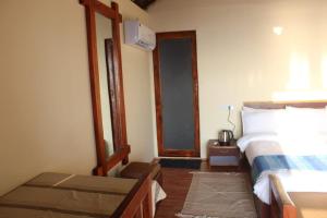 a bedroom with a bed and a table and a mirror at Agonda Wellness in Agonda