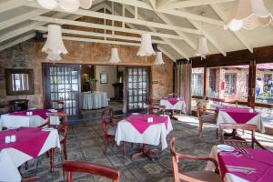 a restaurant with red and white tables and chairs at Critchley Hackle in Dullstroom