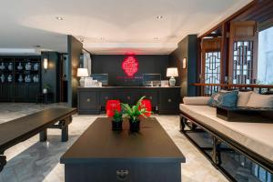 a living room with a couch and a table at The Lantern Hatyai Hotel in Hat Yai