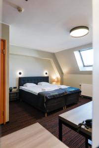 Ένα ή περισσότερα κρεβάτια σε δωμάτιο στο Braavo Spa Hotel