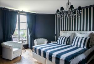 a bedroom with a bed and a chandelier at Château de Planchevienne in Magny-Cours