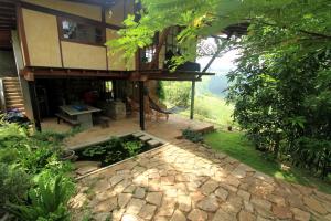 a house with a patio and a stone walkway at Lands End Kandy in Kandy