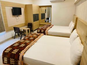 a hotel room with two beds and a tv at Siddharth BnB - Near Golden Temple in Amritsar