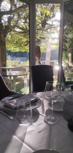 a table with a white table cloth and glasses on it at Hotel Le Rivage in Olivet