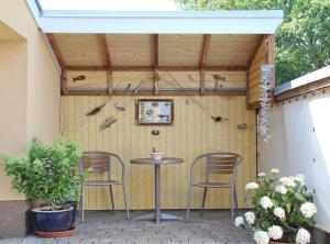 a patio with two chairs and a table at Ferienwohnung Lotse in Schaprode