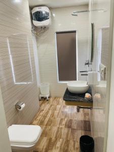 a bathroom with a sink and a toilet and a mirror at Siddharth BnB - Near Golden Temple in Amritsar +76 photos