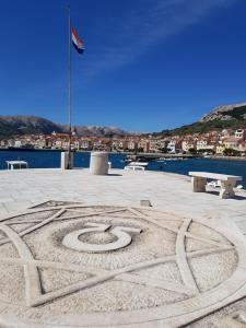 a peace sign in the sand in a park at Apartments Mrkus in Baška