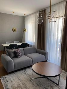a living room with a couch and a table at Nivalis Residence Jahorina in Jahorina