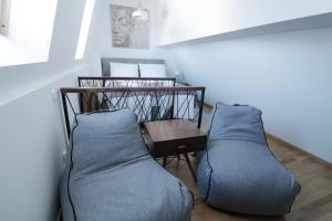 a living room with two pillows and a table at Nivalis Residence Jahorina in Jahorina