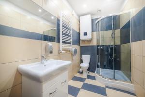 a bathroom with a sink and a shower and a toilet at Dizzy Daisy Downtown Apartments in Krakow